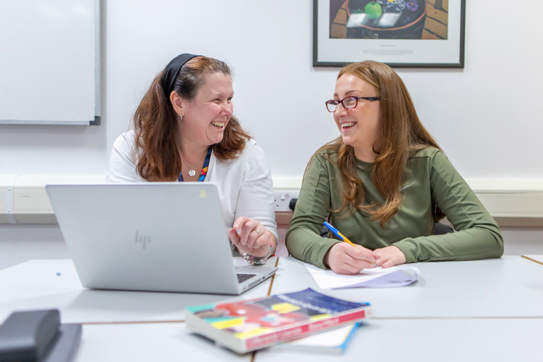 A joyful interaction captured between a Glasgow Kelvin College lecturer and student, emphasising the positive, welcoming learning environment.