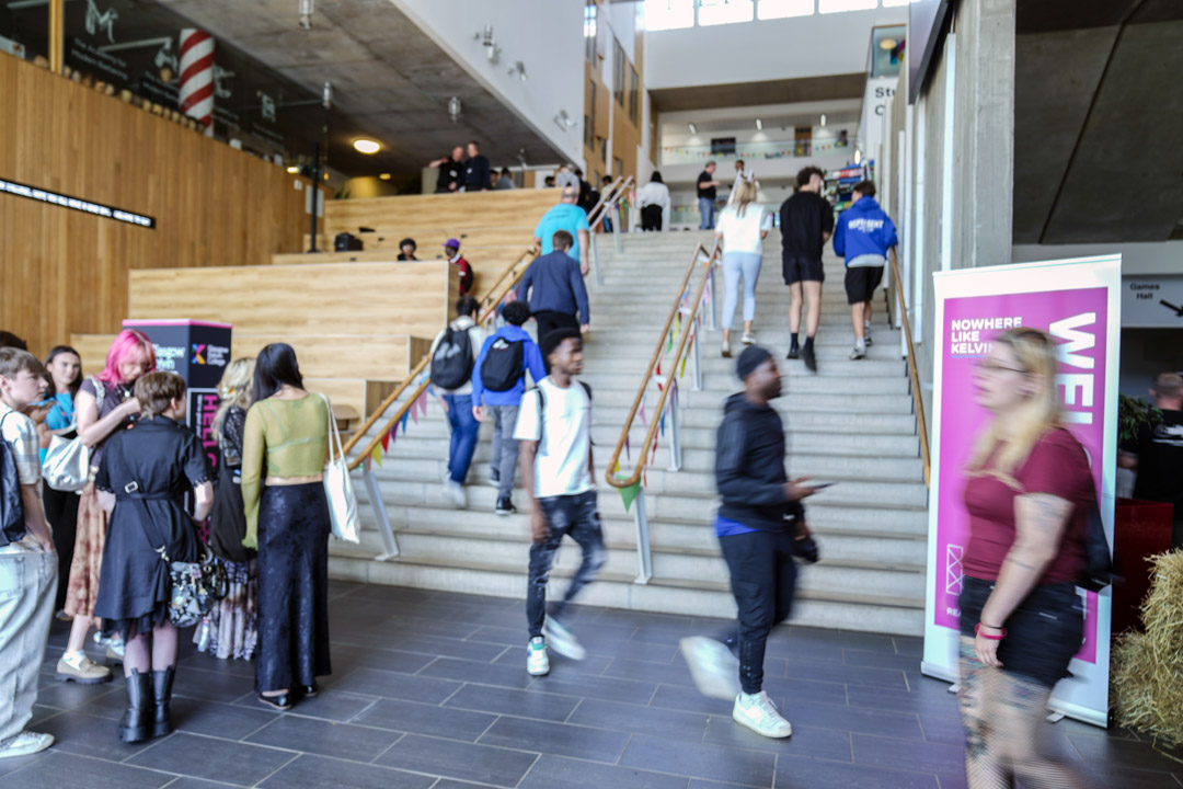 Students walking up the central staircase at Glasgow Kelvin College Springburn campus during a busy Open Day event
