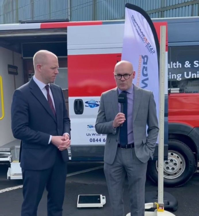 Assistant Principal of Glasgow Kelvin College being interviewed beside the College's rail engineering training vehicle during an engineering and rail partnership event.