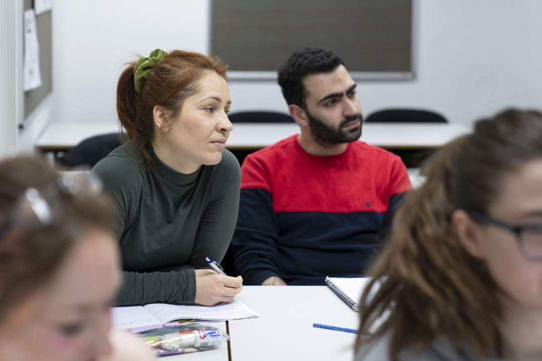 Two students listening intently during a humanities lesson at Glasgow Kelvin College