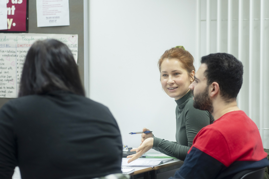 Students in discussion during a humanities class at Glasgow Kelvin College, sharing ideas and taking notes.