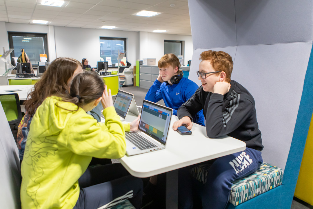 Group of students working together on laptops in the Flexible Learning Centre at Glasgow Kelvin College’s Easterhouse campus.