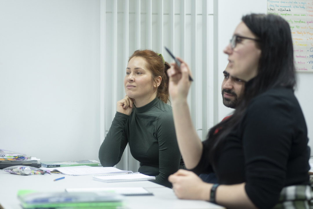 Students actively listening and participating in a humanities class at Glasgow Kelvin College.