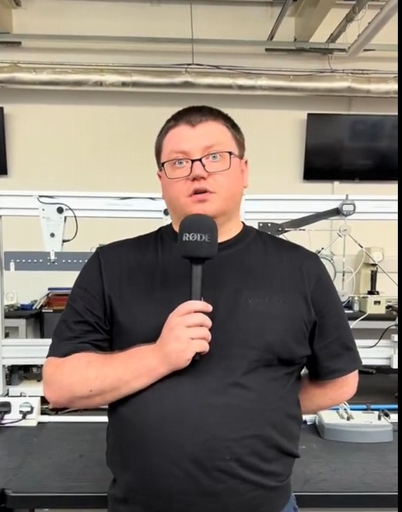Electrical Engineering student speaking into a microphone in an engineering workshop at Glasgow Kelvin College.