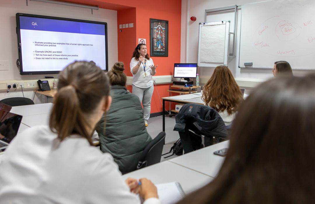 Glasgow Kelvin College students actively participating in class, guided by their lecturer through interactive discussions and activities.