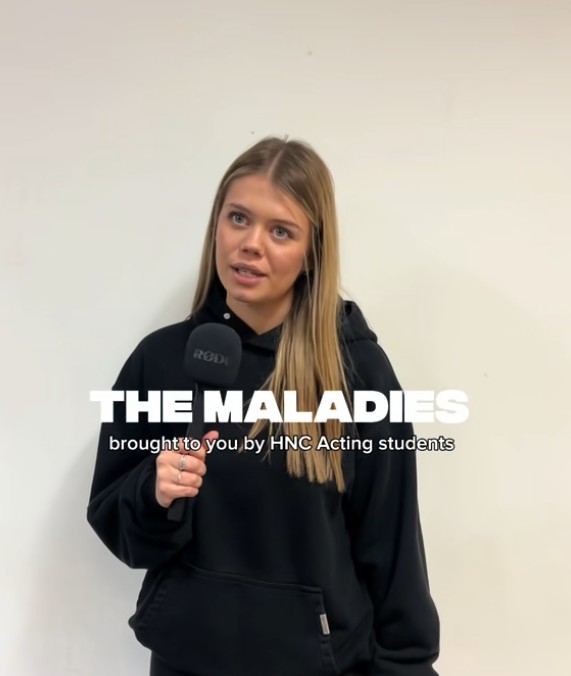 HNC Acting student speaking into a microphone while promoting “The Maladies” performance at Glasgow Kelvin College.